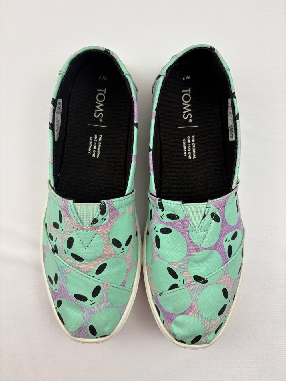 TOMS Alpargata Cupsole slip-on shoes featuring a glow-in-the-dark alien pattern